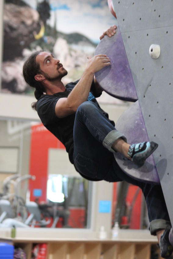 Earth Treks climbing instructor Adam Avello makes his way up a bouldering route. "Climbing is about facing your fears," Avello said. "It's about pushing forward and focusing on your goal. It's analgous to life."